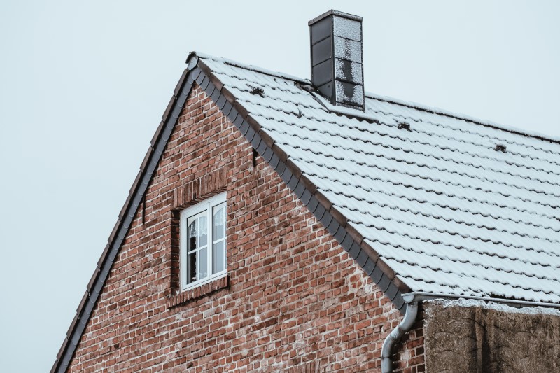 Roof Of A House Covered By Snow In Winter